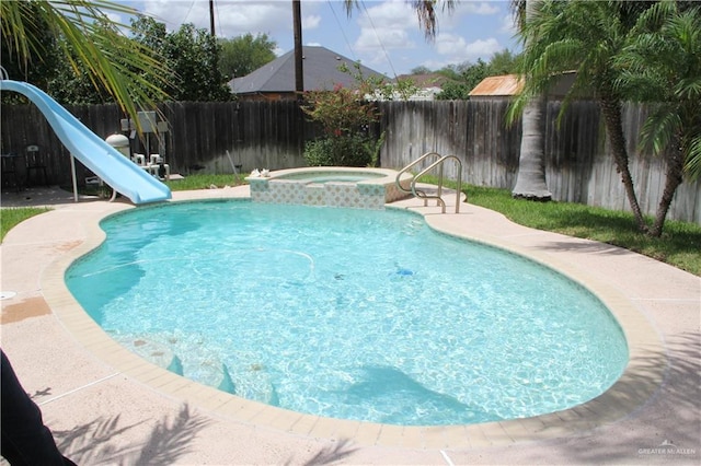1405 S Brier St, Alton, TX 78573 - view of pool featuring a water slide, a fenced backyard, and a pool with connected hot tub