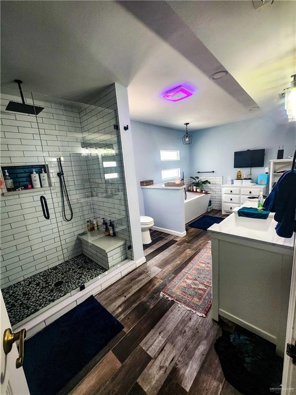 1405 S Brier St, Alton, TX 78573 - bathroom with a shower stall, wood finished floors, and vanity