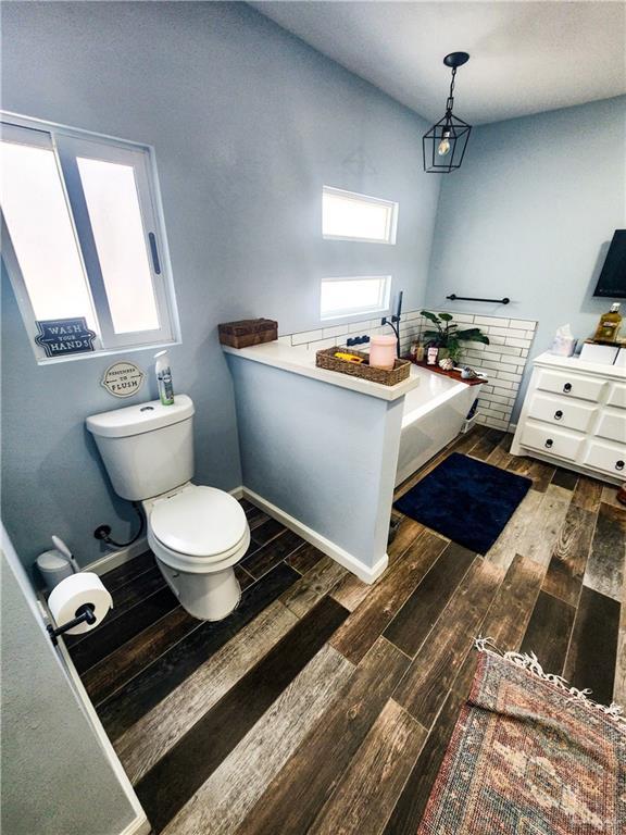 1405 S Brier St, Alton, TX 78573 - bathroom featuring toilet and wood finished floors