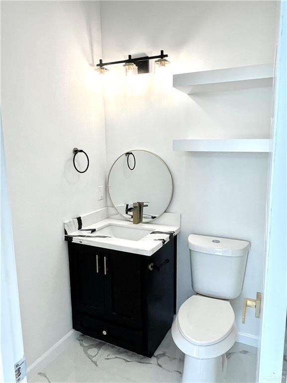 bathroom featuring vanity and toilet