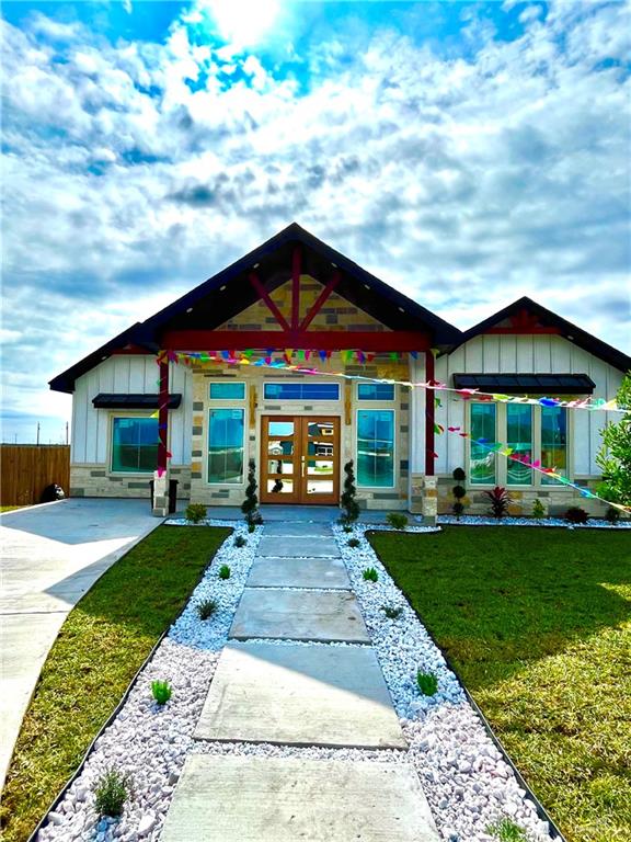 view of front facade featuring a front yard and french doors