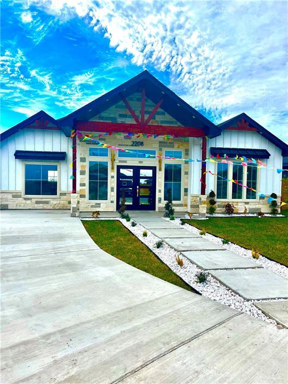 view of front of house featuring a front yard and french doors