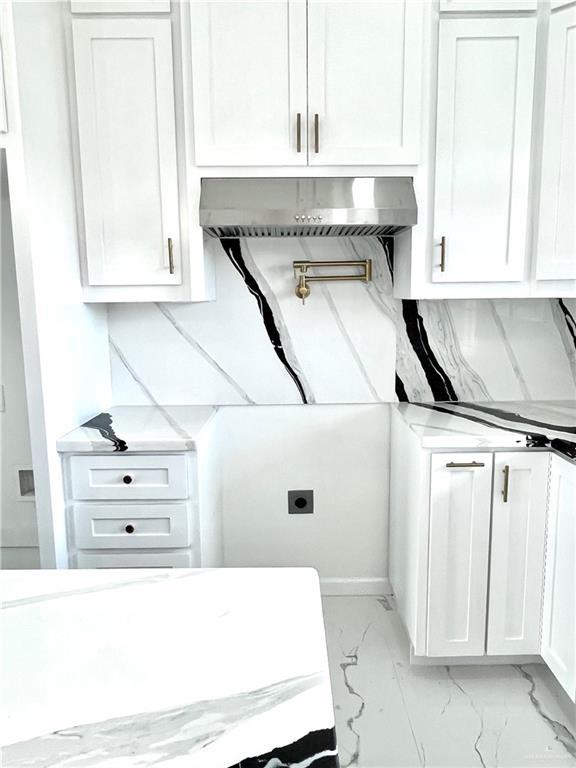 laundry area with cabinets and hookup for an electric dryer