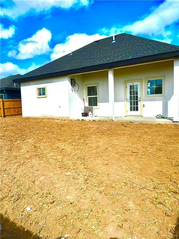 back of property with a patio