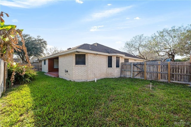 rear view of house featuring a yard