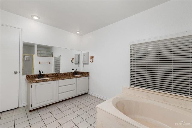 bathroom with tile patterned flooring, vanity, and separate shower and tub