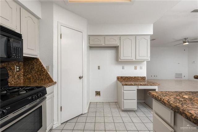 kitchen with white cabinetry, ceiling fan, stainless steel range with gas cooktop, and dark stone countertops