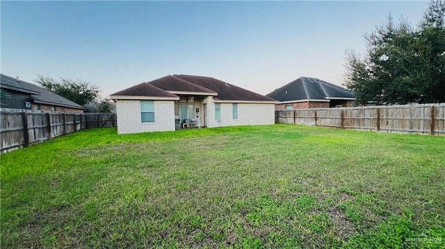 back of property featuring a lawn