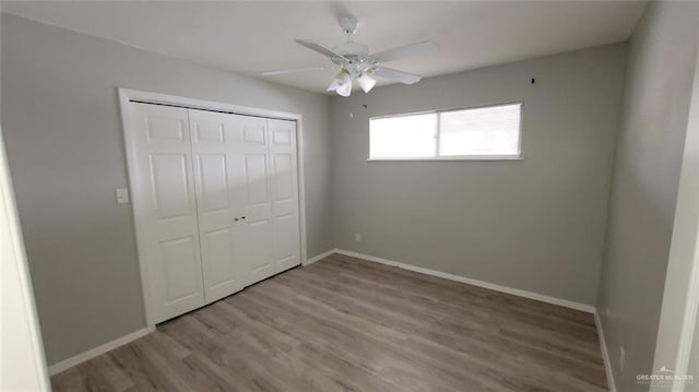1600 Bridge Ave Unit 207, Weslaco, TX 78596 - unfurnished bedroom featuring wood finished floors, a closet, baseboards, and ceiling fan