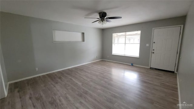 1600 Bridge Ave Unit 207, Weslaco, TX 78596 - spare room featuring a ceiling fan, wood finished floors, and baseboards
