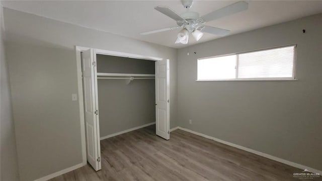 1600 Bridge Ave Unit 207, Weslaco, TX 78596 - unfurnished bedroom with wood finished floors, baseboards, a closet, and a ceiling fan