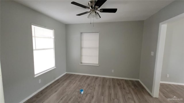 1600 Bridge Ave Unit 207, Weslaco, TX 78596 - empty room featuring wood finished floors, plenty of natural light, ceiling fan, and baseboards