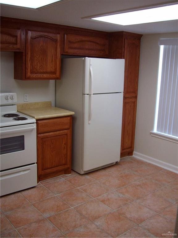 kitchen with light tile patterned floors and white appliances