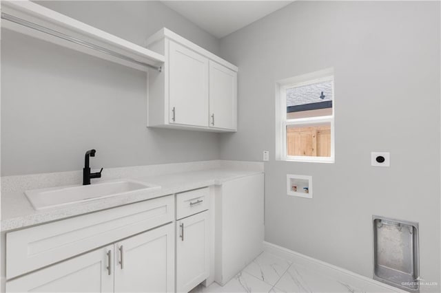 laundry area with washer hookup, electric dryer hookup, cabinets, and sink