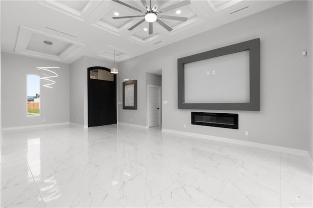 unfurnished living room featuring beamed ceiling, ceiling fan with notable chandelier, and coffered ceiling