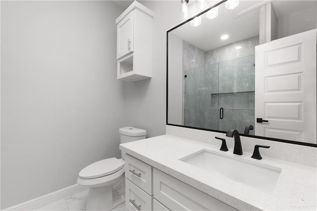 bathroom with vanity, toilet, and a shower with door