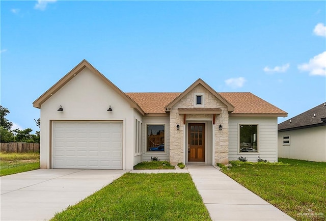 view of front of home with a garage and a front yard