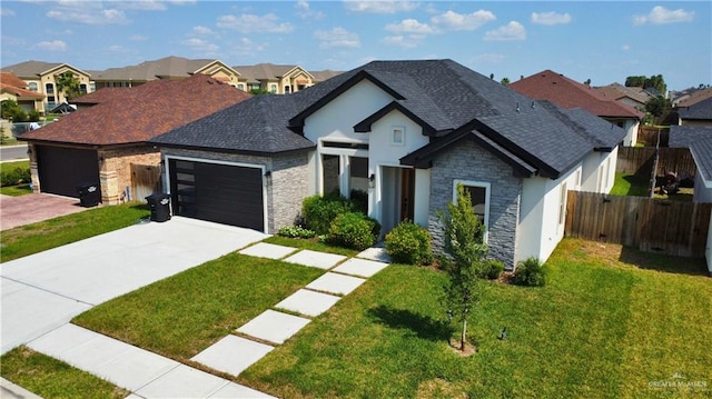 view of front of property featuring a front yard and a garage