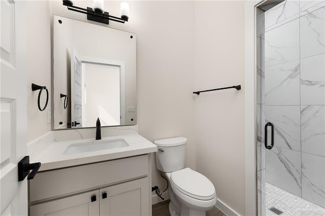 bathroom featuring vanity, an enclosed shower, and toilet