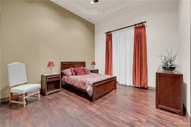 bedroom with visible vents and wood finished floors