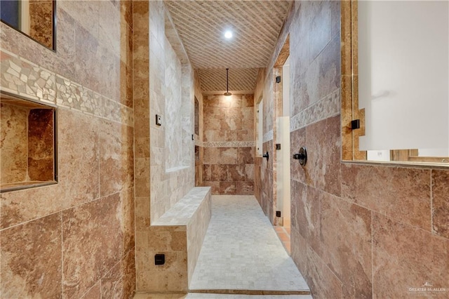 full bath with a tile shower