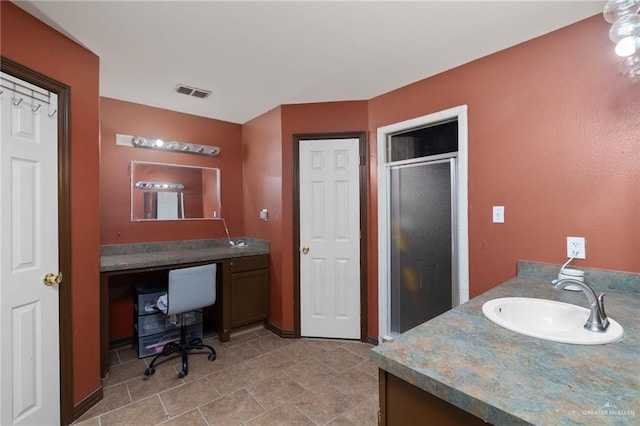 bathroom with vanity and an enclosed shower