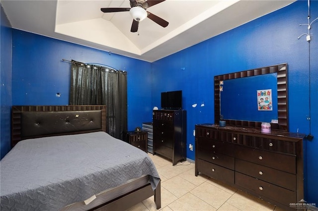 tiled bedroom with ceiling fan, lofted ceiling, and a raised ceiling