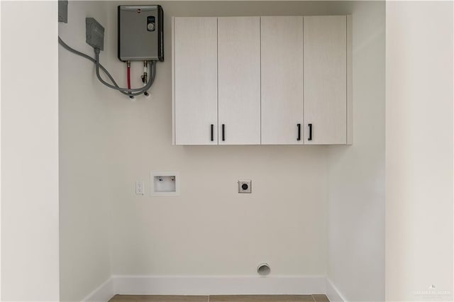 washroom with baseboards, cabinet space, hookup for an electric dryer, and washer hookup