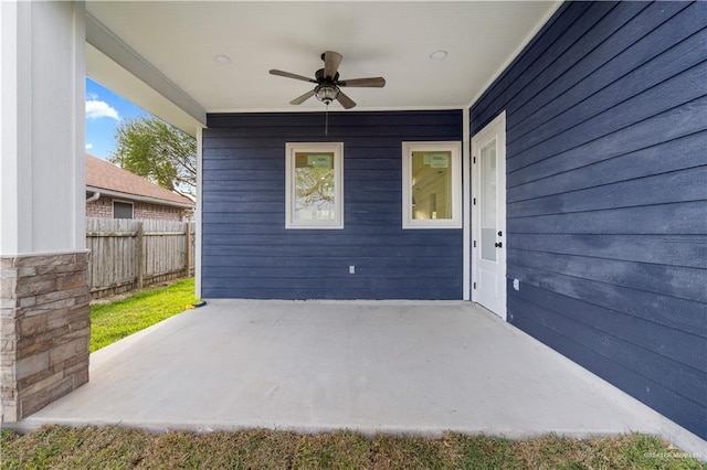 view of patio featuring a ceiling fan and fence