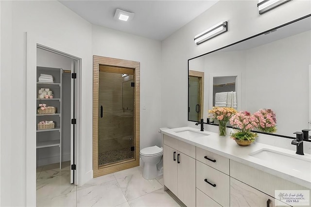 full bathroom with a sink, toilet, marble finish floor, and a shower stall