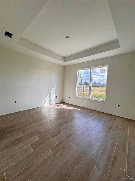 spare room featuring a tray ceiling