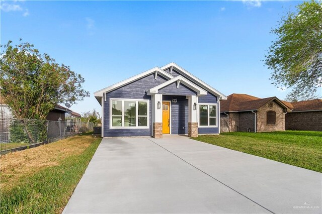 craftsman house with a front lawn and fence