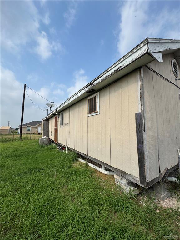 9924 Marisol St, Edinburg, TX 78542 - view of side of property featuring a lawn