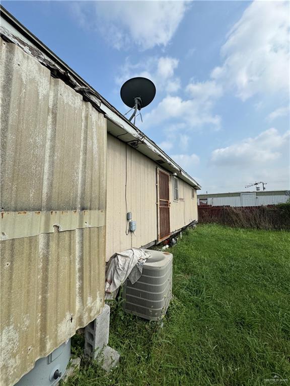 9924 Marisol St, Edinburg, TX 78542 - view of property exterior featuring central AC unit and a yard