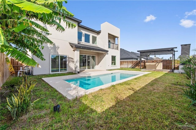 back of house featuring a fenced in pool, a yard, a pergola, and a patio area