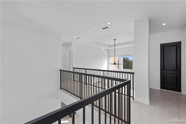 hall with light tile patterned floors