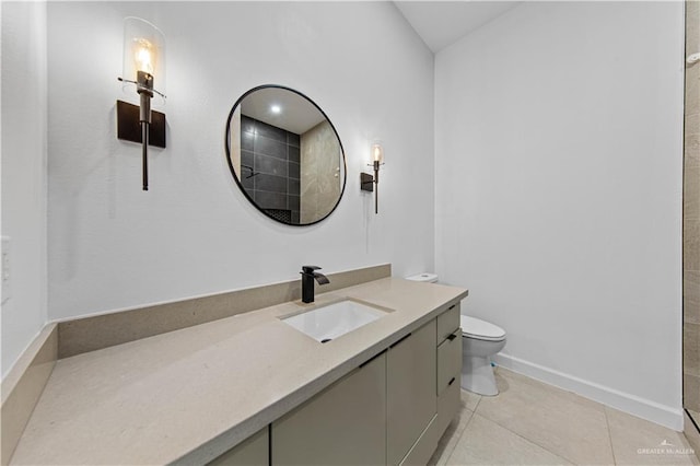 bathroom featuring vanity, toilet, and tile patterned flooring