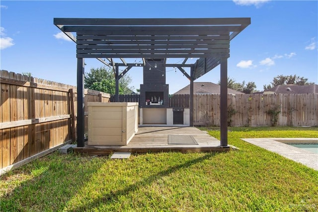 view of yard with exterior fireplace and a pergola