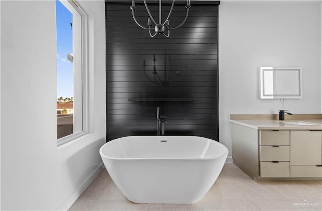 bathroom featuring wooden walls, vanity, a bath, and tile patterned flooring