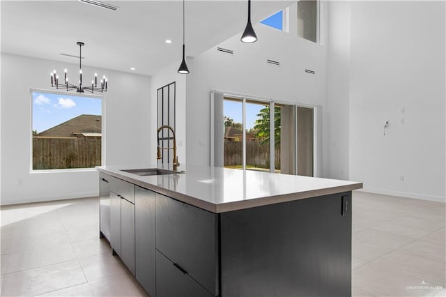 kitchen featuring pendant lighting, sink, a healthy amount of sunlight, and a spacious island