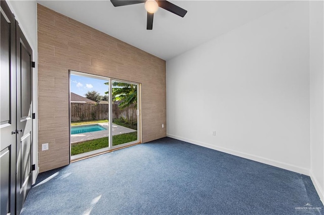 carpeted empty room featuring ceiling fan