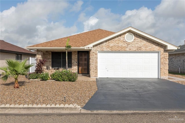 1815 Wilson St, Mission, TX 78572 - ranch-style home featuring asphalt driveway, brick siding, and an attached garage