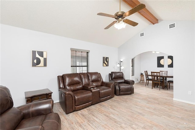 1815 Wilson St, Mission, TX 78572 - living area featuring a ceiling fan, arched walkways, beam ceiling, light wood-style flooring, and high vaulted ceiling