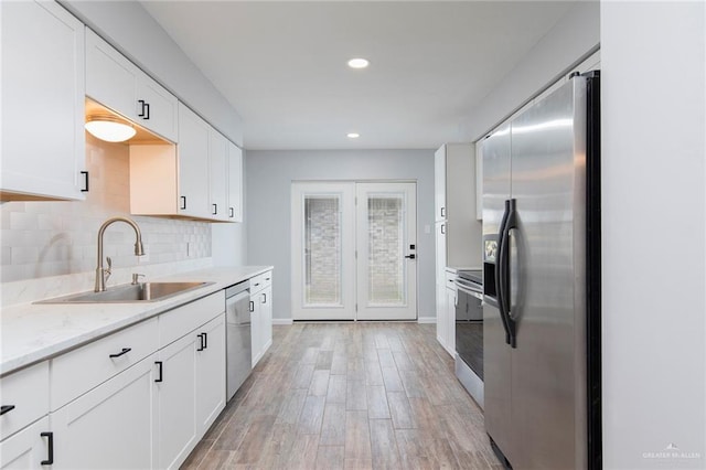 1815 Wilson St, Mission, TX 78572 - kitchen featuring stainless steel appliances, recessed lighting, white cabinets, backsplash, and light wood-style flooring