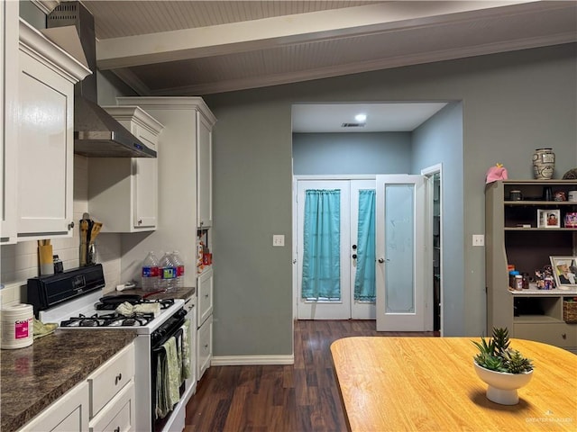 13307 Ash Ave, Edinburg, TX 78542 - kitchen featuring gas range, dark wood-style flooring, wall chimney range hood, white cabinets, and backsplash