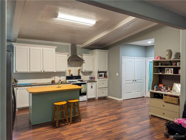 13307 Ash Ave, Edinburg, TX 78542 - kitchen with white gas range, wall chimney range hood, white cabinetry, dark wood finished floors, and ornamental molding