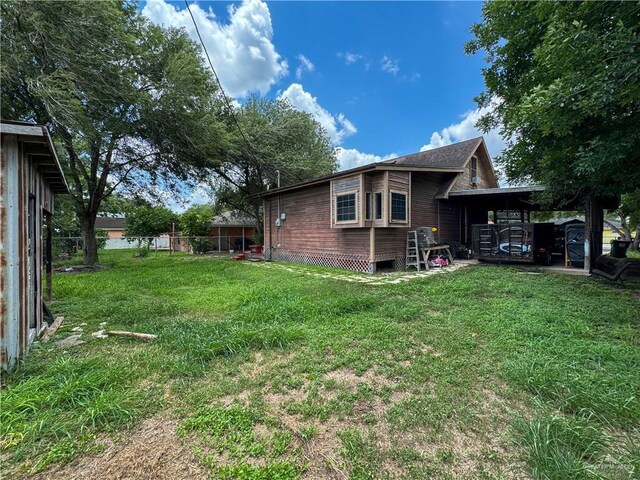 13307 Ash Ave, Edinburg, TX 78542 - view of grassy yard featuring an attached carport