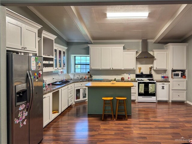 13307 Ash Ave, Edinburg, TX 78542 - kitchen featuring stainless steel appliances, wall chimney range hood, beamed ceiling, dark wood-style floors, and backsplash