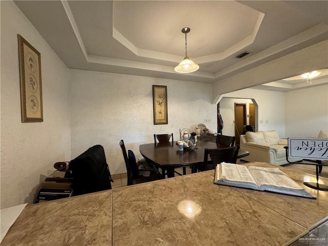 dining room with a tray ceiling