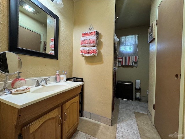 bathroom with tile patterned floors and vanity